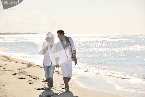 Image of happy young couple have fun at beautiful beach