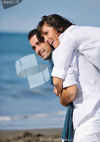 Image of happy young couple have fun at beautiful beach