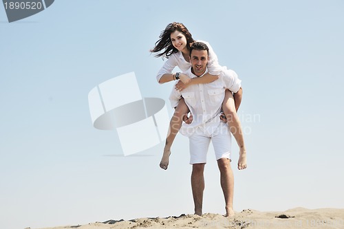 Image of happy young couple have fun on beach