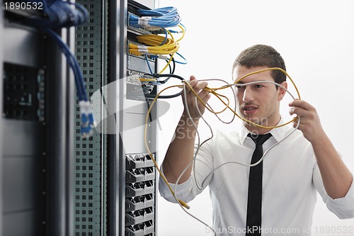 Image of young it engeneer in datacenter server room