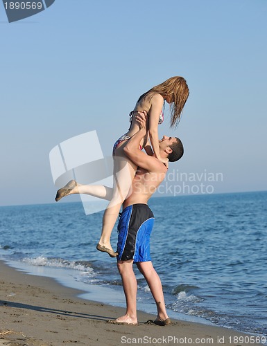 Image of happy young couple have romantic time on beach