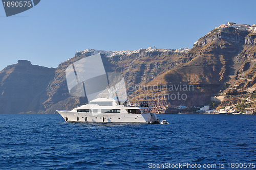 Image of santorini island coast with luxury yacht