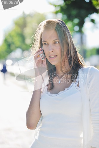 Image of young woman talk by cellphone on street