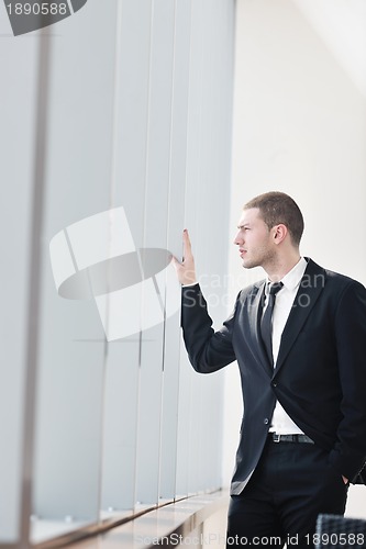 Image of young business man alone in conference room