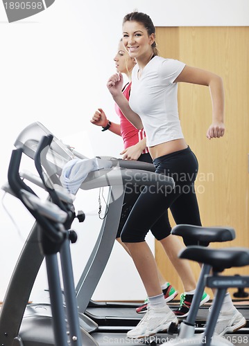 Image of womanworkout  in fitness club on running track machine 