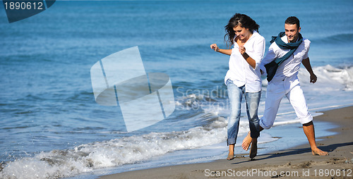 Image of happy young couple have fun at beautiful beach