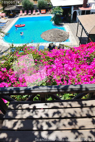 Image of romantic balcony with flowers and pool view