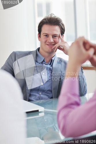 Image of young business man alone in conference room