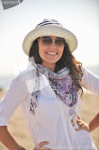 Image of happy young woman on beach