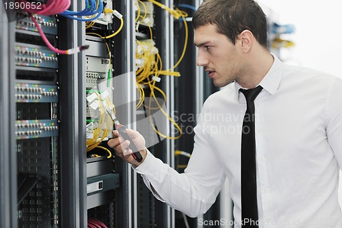 Image of young it engeneer in datacenter server room