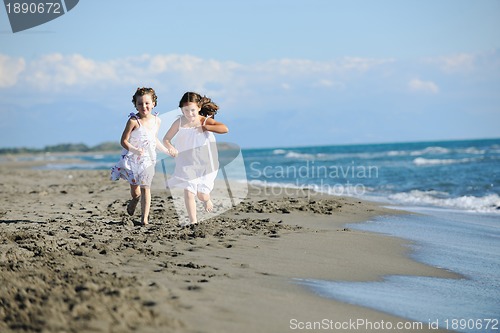 Image of cute little girls running on beach