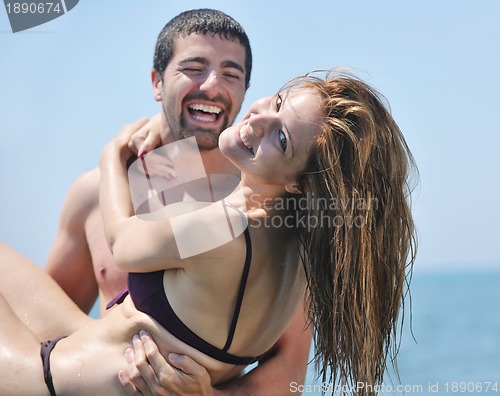 Image of happy young couple have romantic time on beach