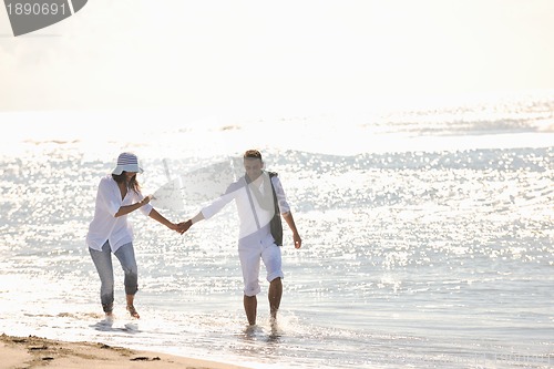Image of happy young couple have fun at beautiful beach