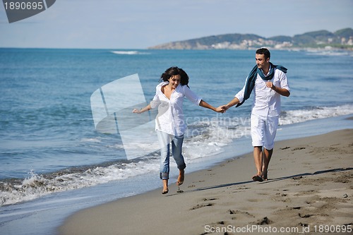 Image of happy young couple have fun at beautiful beach