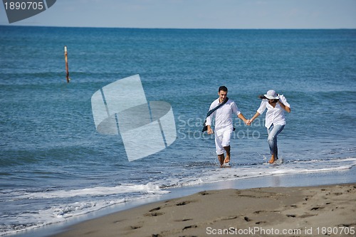 Image of happy young couple have fun at beautiful beach