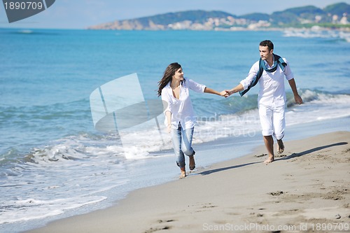 Image of happy young couple have fun at beautiful beach
