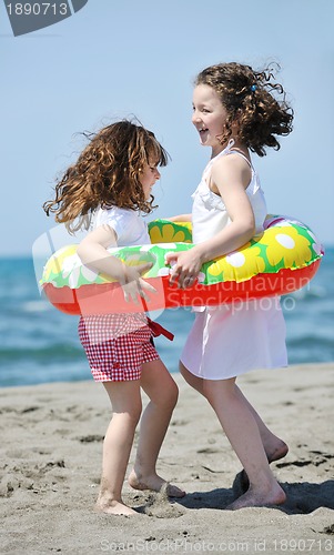 Image of happy child group playing  on beach