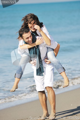 Image of happy young couple have fun at beautiful beach