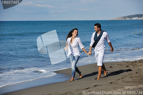 Image of happy young couple have fun at beautiful beach