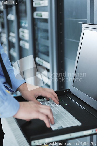 Image of young it engeneer in datacenter server room