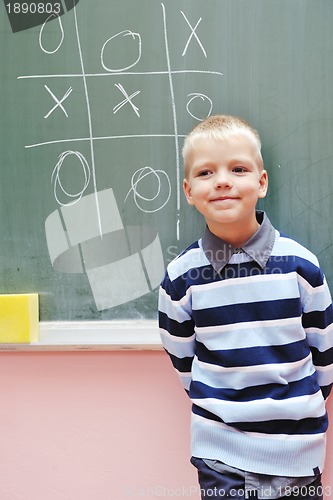 Image of happy young boy at first grade math classes 