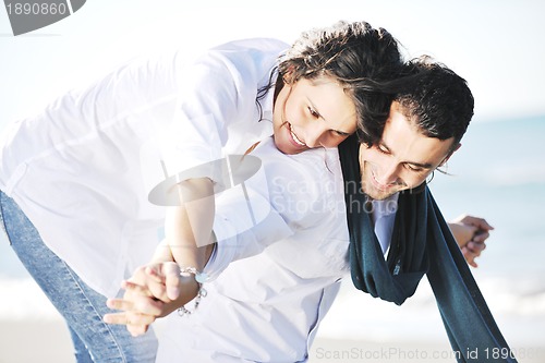 Image of happy young couple have fun at beautiful beach