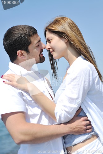 Image of happy young couple have fun on beach