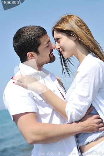 Image of happy young couple have fun on beach