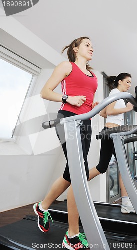 Image of woman workout  in fitness club on running track 