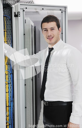 Image of young it engeneer in datacenter server room