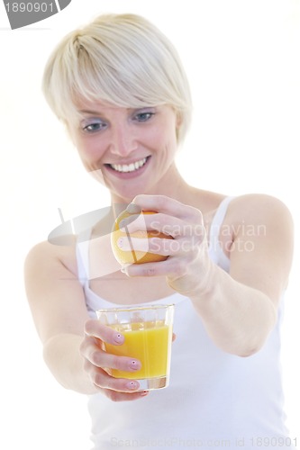 Image of Young woman squeeze orange juice