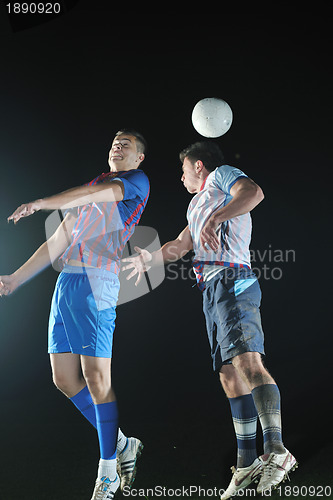 Image of football players in competition for the ball