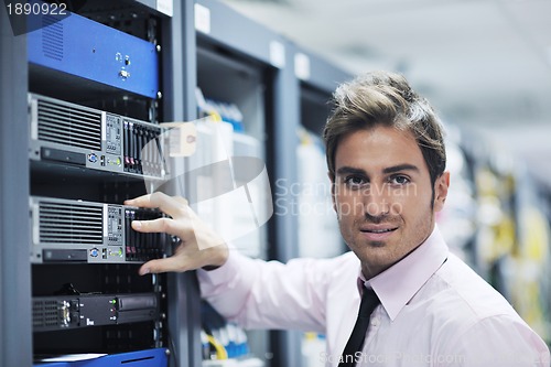 Image of young it engineer in datacenter server room