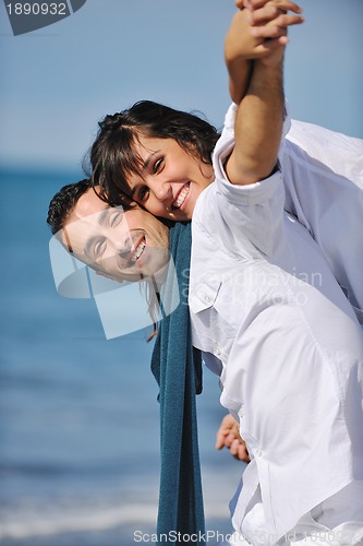 Image of happy young couple have fun at beautiful beach