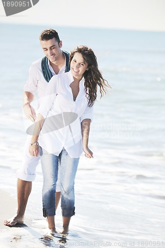 Image of happy young couple have fun at beautiful beach