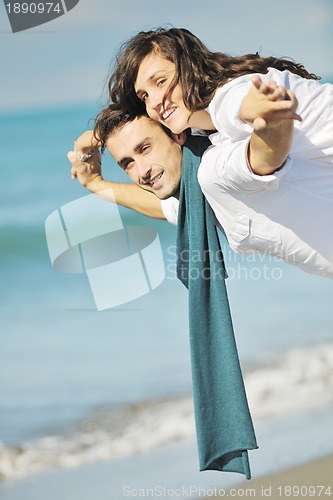 Image of happy young couple have fun at beautiful beach