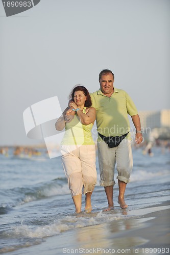 Image of happy seniors couple  on beach