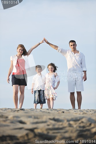 Image of family on beach showing home sign