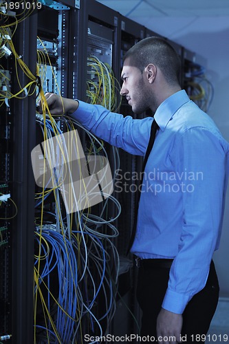 Image of young it engineer in datacenter server room