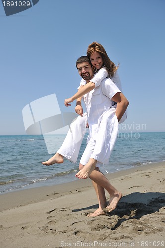 Image of happy young couple have fun on beach