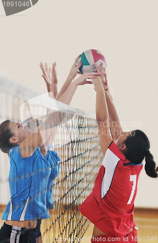 Image of girls playing volleyball indoor game