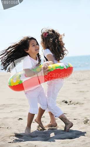 Image of happy child group playing  on beach