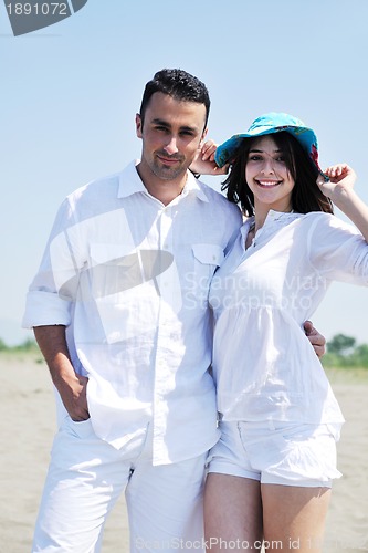 Image of happy young couple have fun on beach