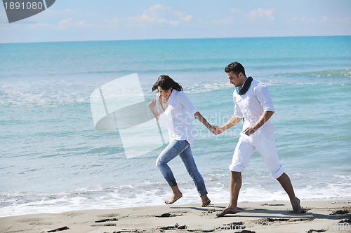 Image of happy young couple have fun at beautiful beach