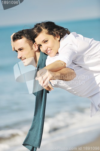 Image of happy young couple have fun at beautiful beach