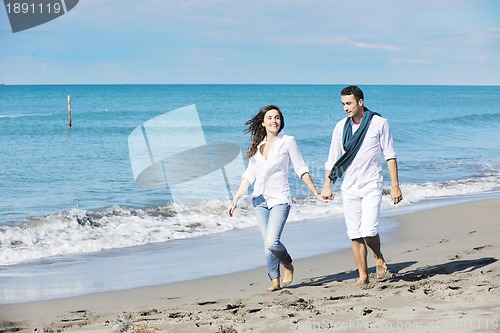 Image of happy young couple have fun at beautiful beach