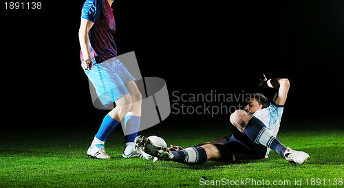 Image of football players in competition for the ball