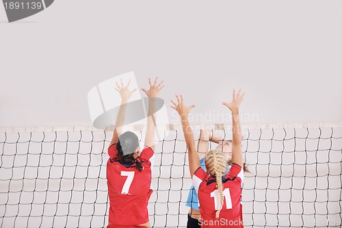 Image of girls playing volleyball indoor game