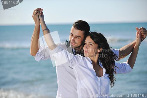 Image of happy young couple have fun at beautiful beach