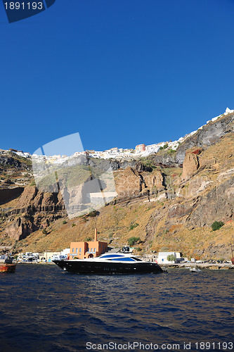 Image of santorini island coast with luxury yacht